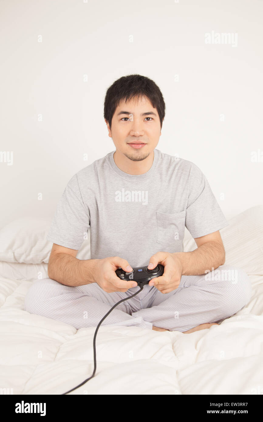 Young man in his bedroom Stock Photo