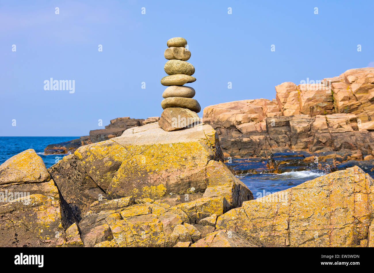 Balancing pebbles, rocky coast and Baltic Sea at Hovs Hallar, Sweden. Stock Photo