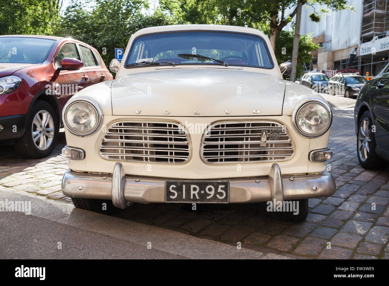 Helsinki, Finland - June 13, 2015: Old white Volvo Amazon 121 B12 car is parked on the roadside in Helsinki city. Front view Stock Photo