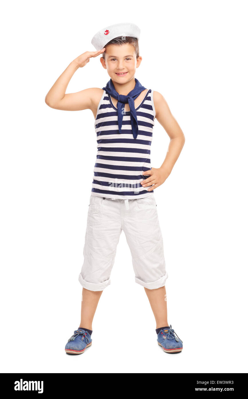 Full length portrait of a cute little kid in a sailor uniform saluting towards the camera isolated on white background Stock Photo