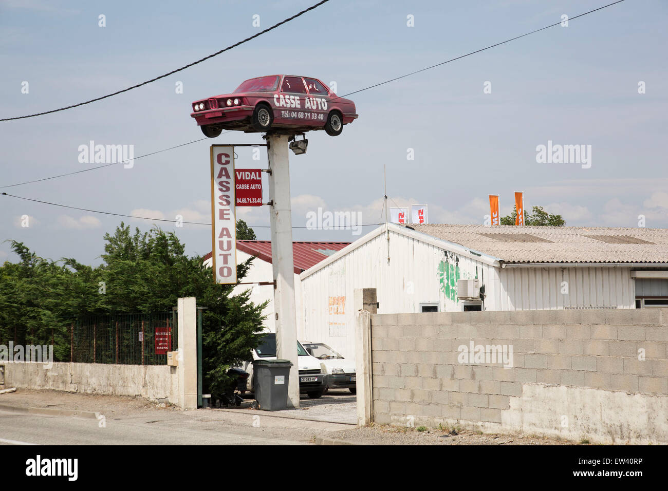 BMW car raised high above a Casse Auto repair shop in Carcassonne,  Languedoc-Roussillon, France Stock Photo - Alamy
