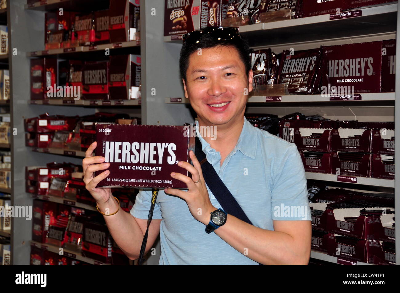 Hershey, PA:   Happy visitor at the Chocolate World store holding a large Hershey's candy bar Stock Photo