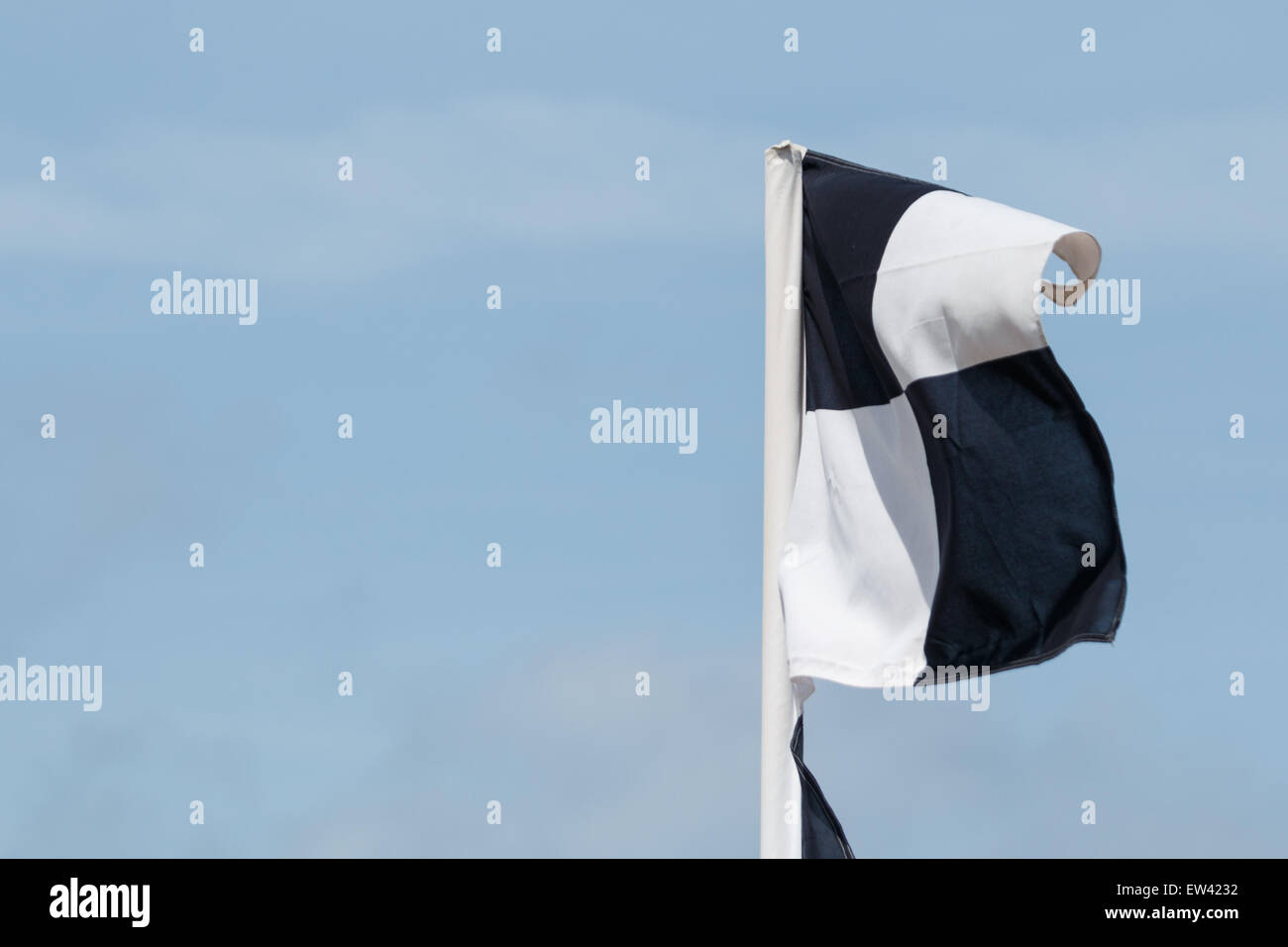 Black and white flags erected by lifeguards (beach patrol) marking the