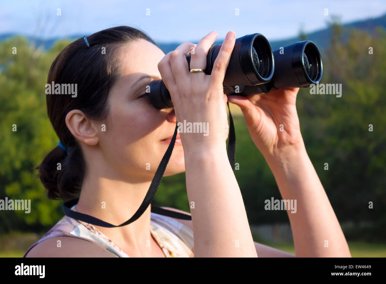 Woman with binoculars Stock Photo