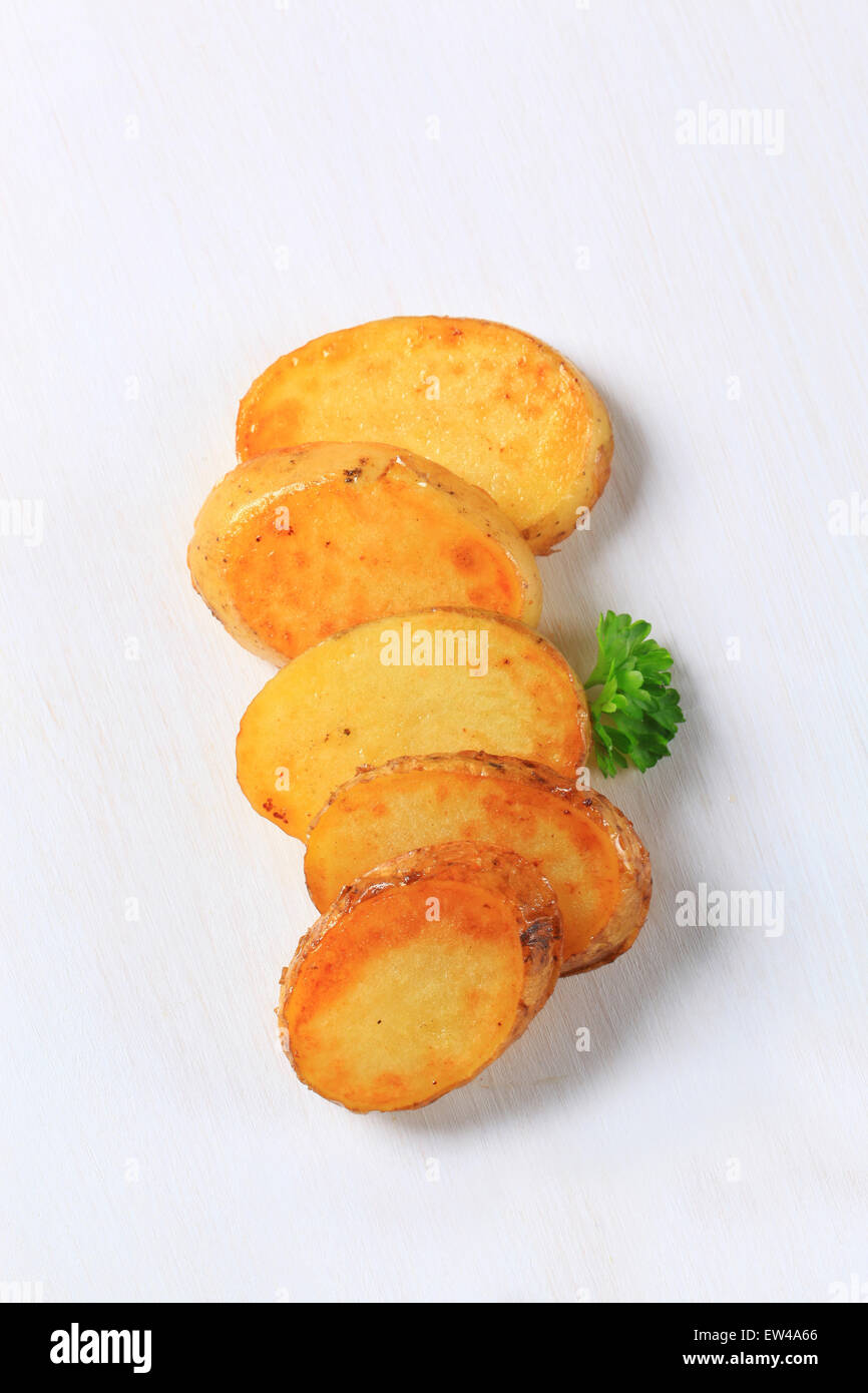 Pan roasted potato slices - studio shot Stock Photo