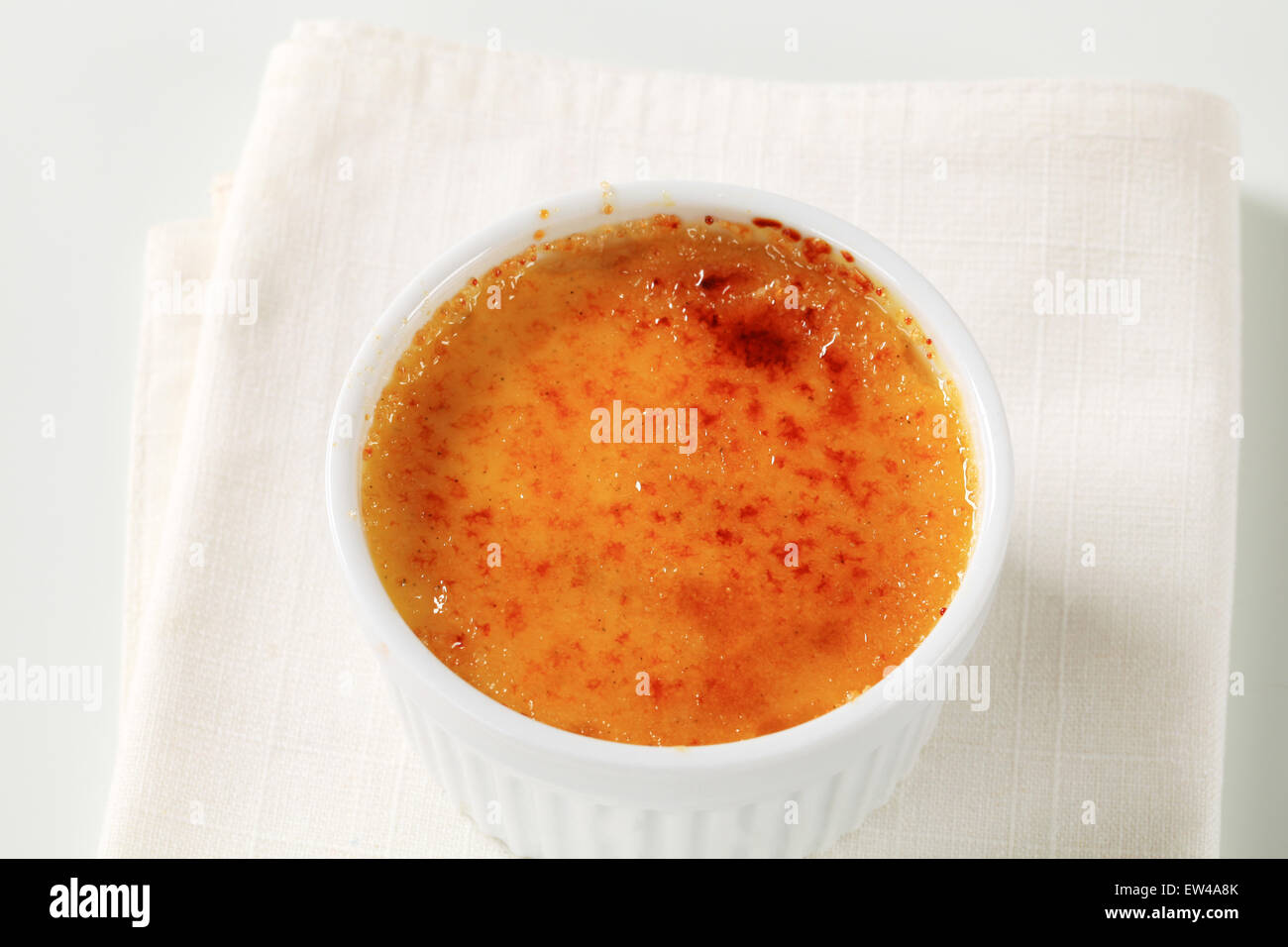 Creme brulee in white ramekin Stock Photo Alamy