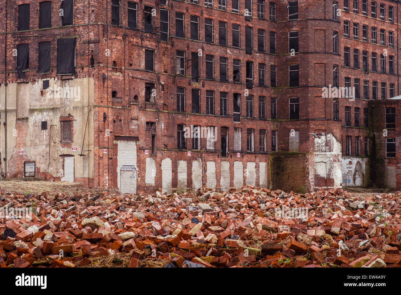 Hunslet Mill in Leeds, surrounded by piles of bricks and rubble from demolished buildings. Stock Photo