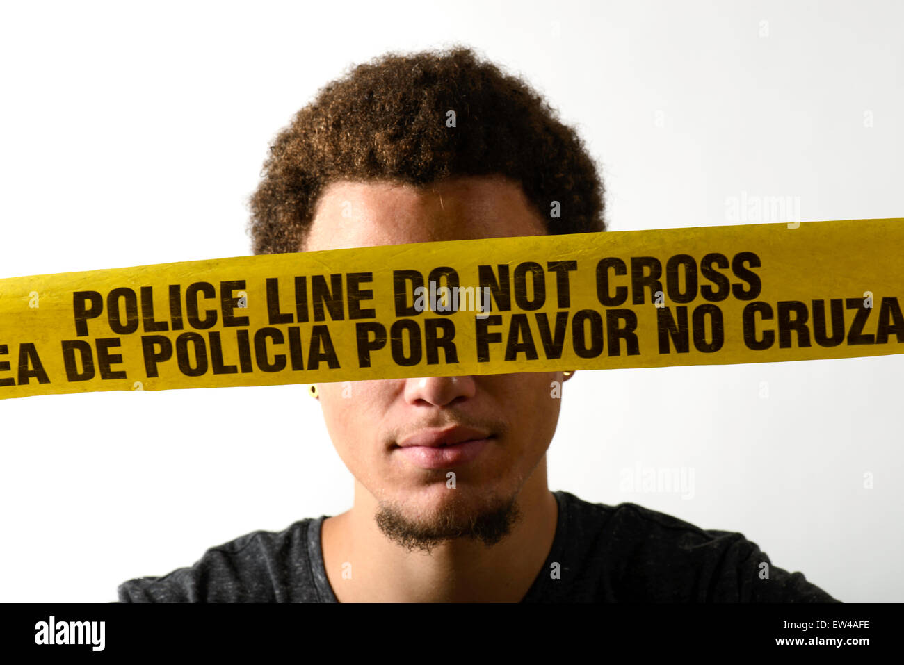 A young man with crime scene tape. Stock Photo