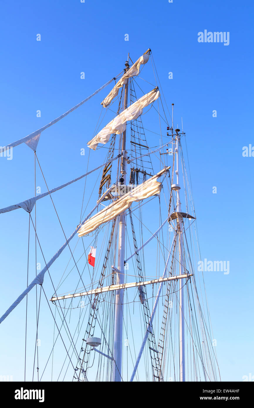 Tall sailing ship mast against a clear blue sky. Stock Photo