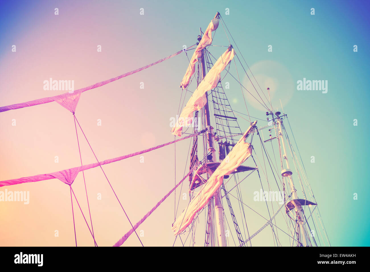 Vintage retro instagram style picture of a sailing ship mast with lens flare effect. Stock Photo