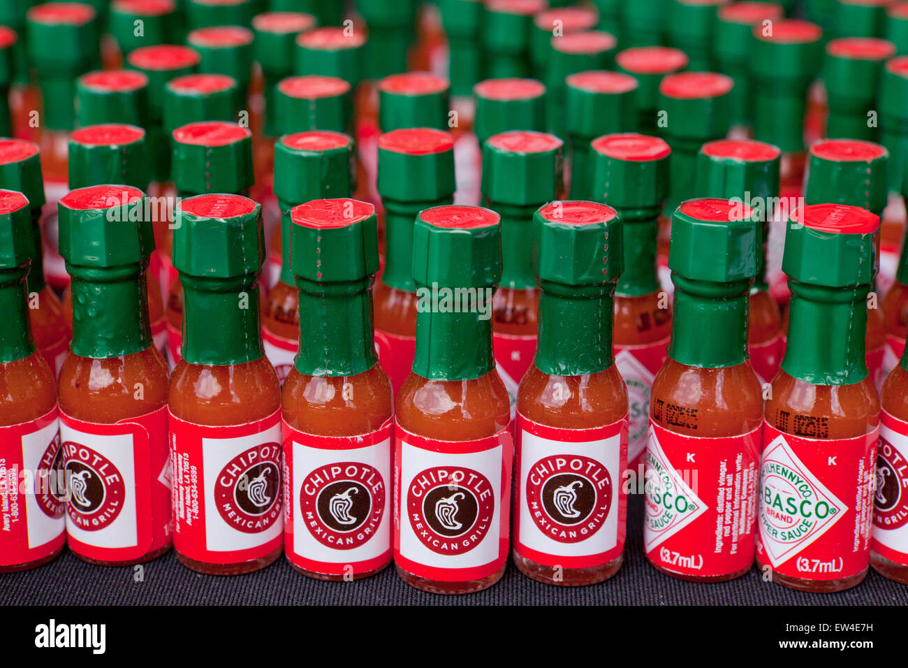 Promotional bottles of Tabasco chili pepper sauce from Chipotle restaurant USA Stock Photo Alamy