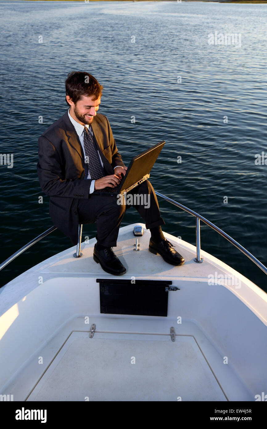 Business man working on boat Stock Photo Alamy