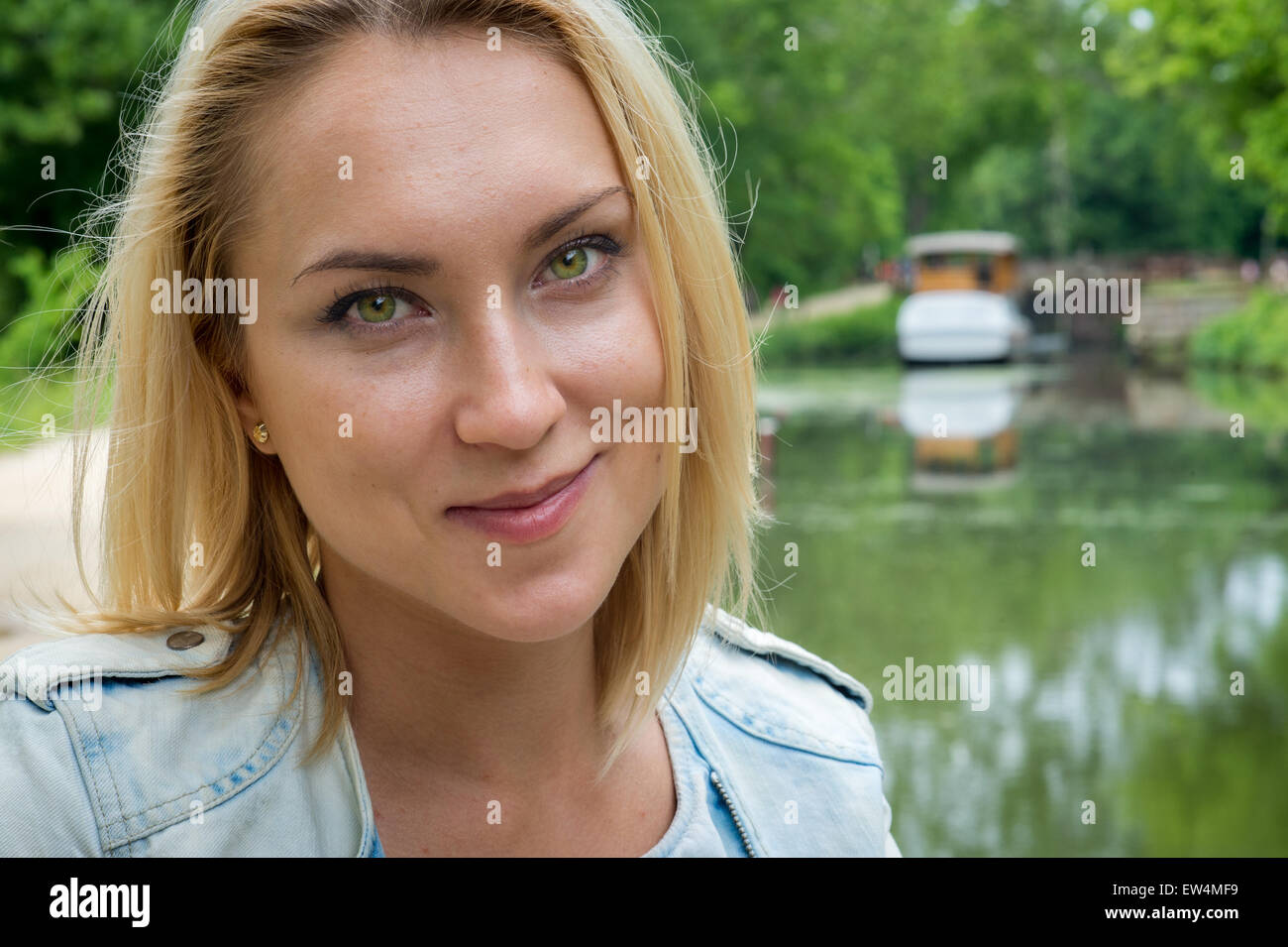 Smiling woman by C&O Canal in Potomac Maryland USA - portrait of blond woman by  C&O canal Stock Photo