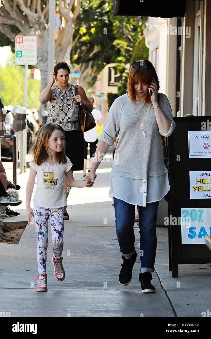 Alyson Hannigan holding hands with her daughter as they go shopping