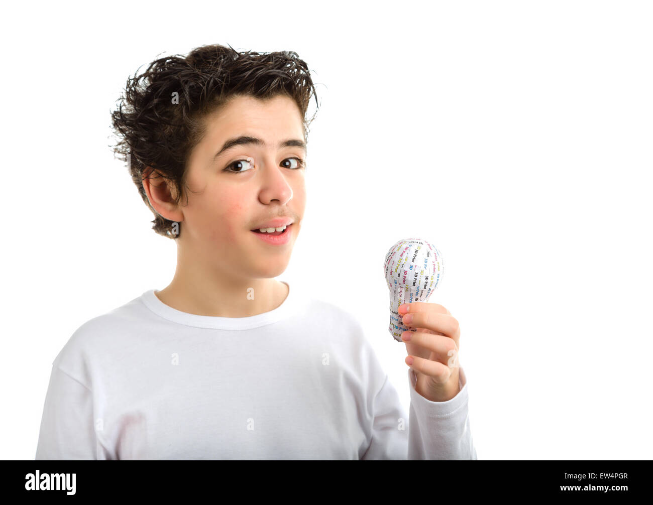 Happy Hispanic boy with soft skin in white long sleeved t-shirt smiles holding 3D printed lightbulb with left hand Stock Photo