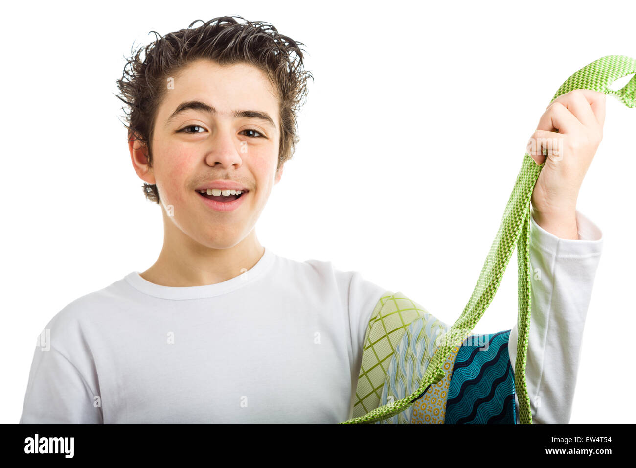 Happy hispanic boy in white long sleeved shirt smiles holding some extravagant and tawdry green ties Stock Photo