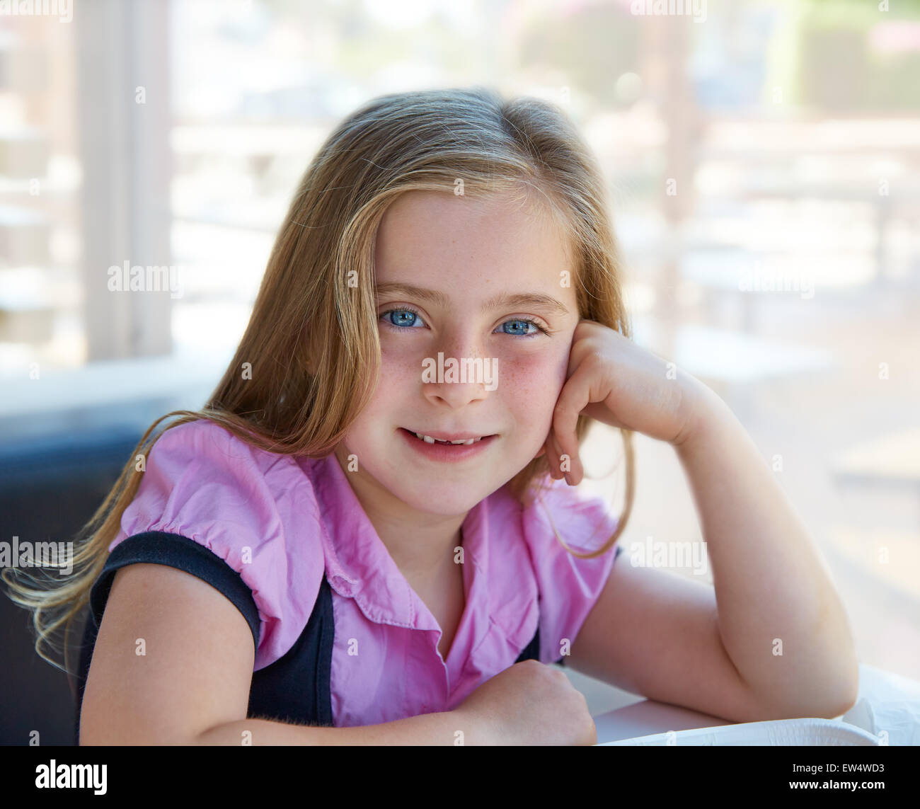 Blond relaxed happy kid girl expression blue eyes smiling Stock Photo