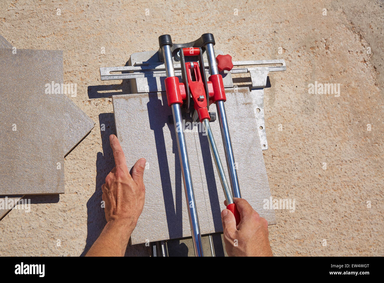 tile cutter machine with mason hands cutting tiles Stock Photo Alamy