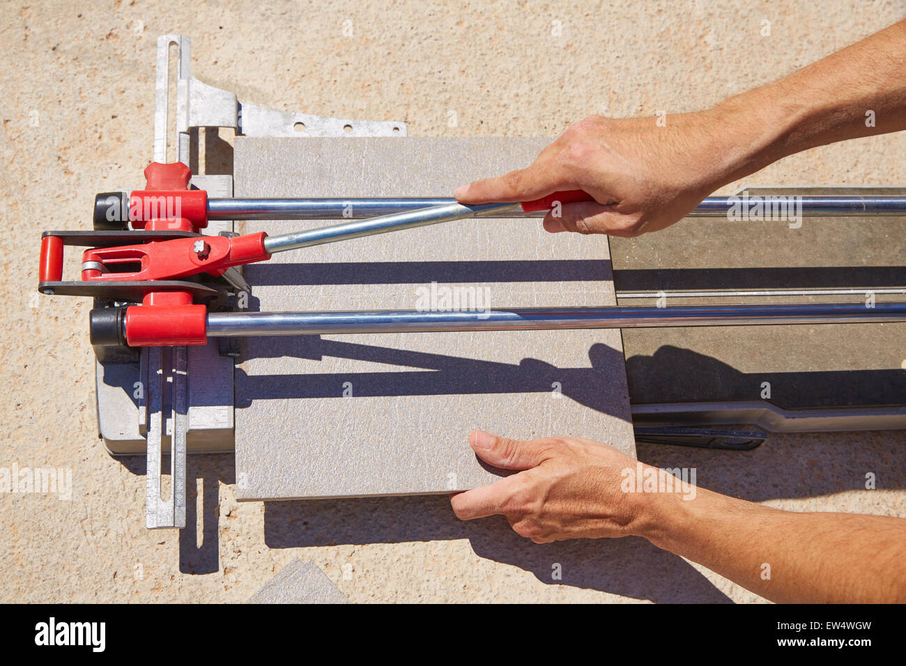 tile cutter machine with mason hands cutting tiles Stock Photo Alamy