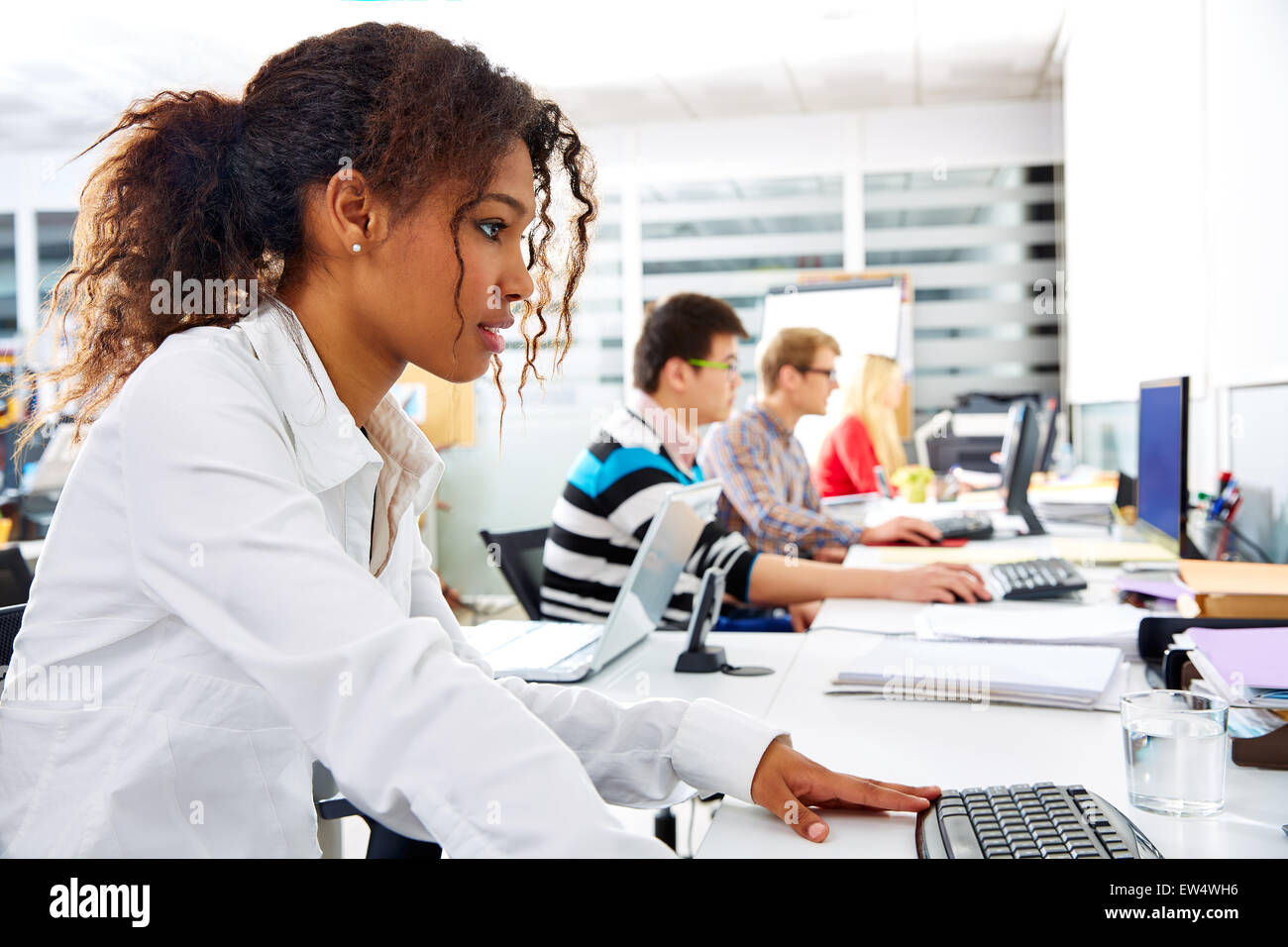 African businesswoman young in office with computer in a desk row Stock ...