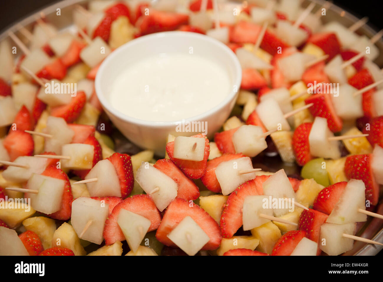 Fruit cocktail on sticks with a fresh cream dip Stock Photo Alamy
