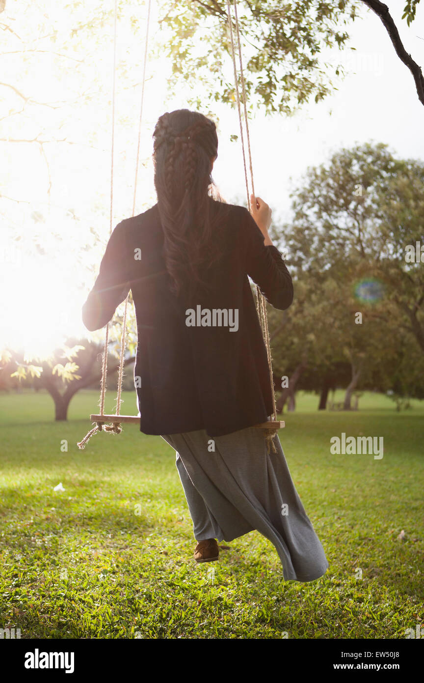 Rear woman on swing hi-res stock photography and images - Alamy