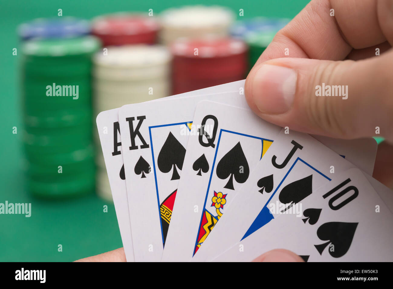 poker player holding 10 to King spade straight flush of pokers, A spade is coming Stock Photo