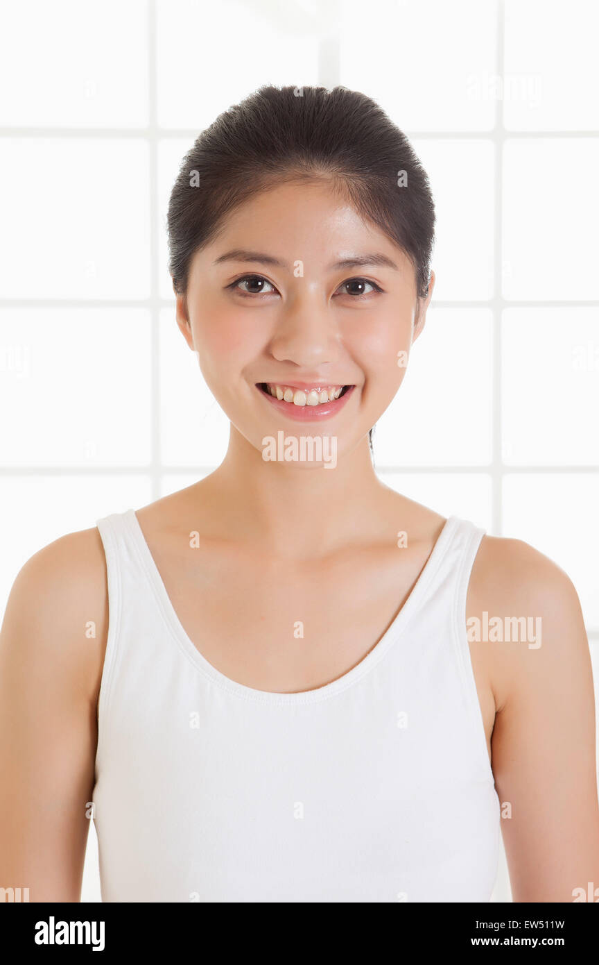 Young woman smiling at the camera Stock Photo - Alamy