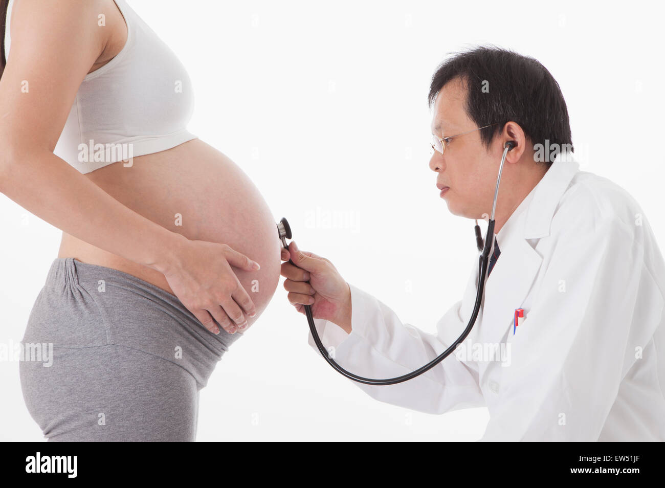 Doctor making medical exam for pregnant woman, Stock Photo