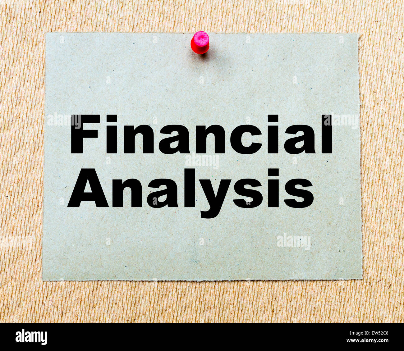 Financial Analysis written on paper note pinned with red thumbtack on ...