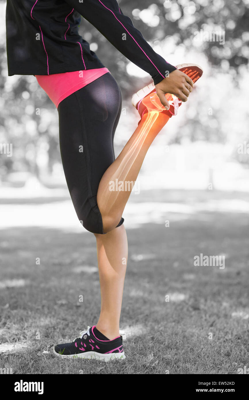 Highlighted leg of stretching woman Stock Photo