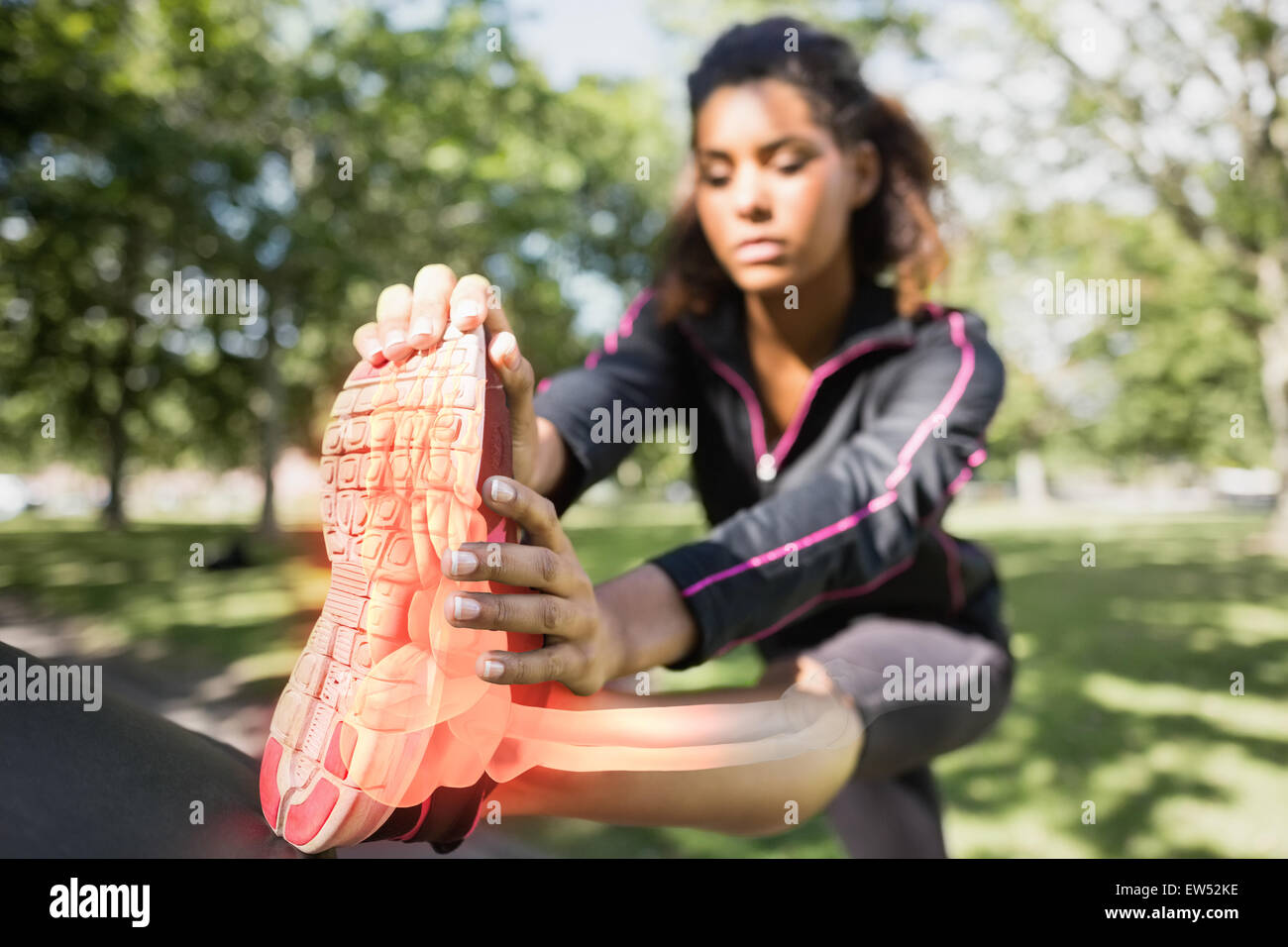 Highlighted ankle of stretching woman Stock Photo