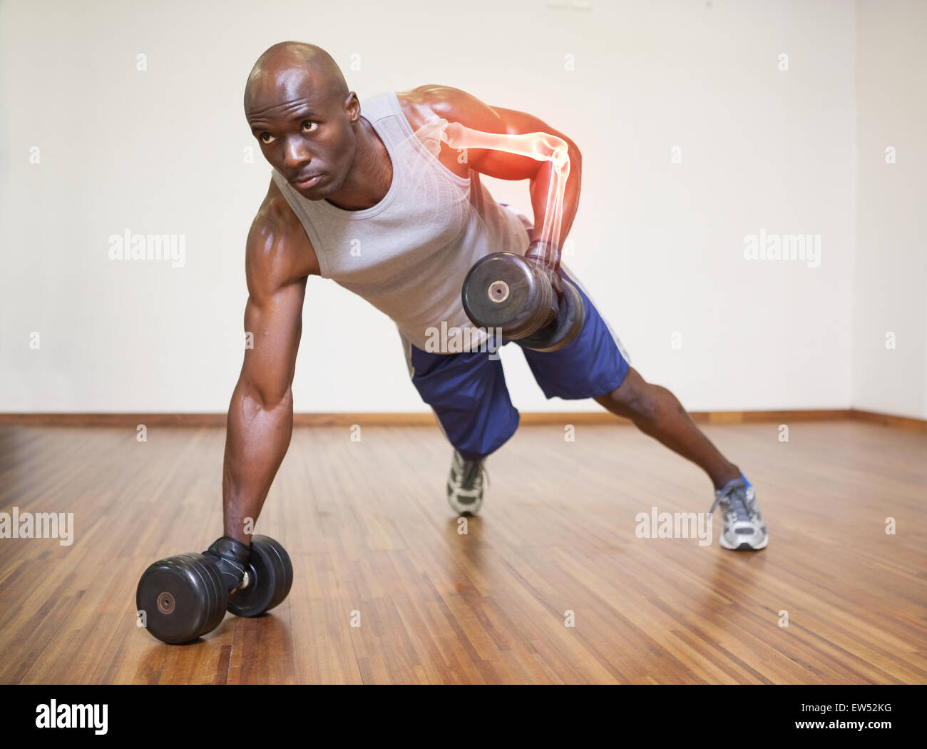 Highlighted arm of strong man lifting weights Stock Photo
