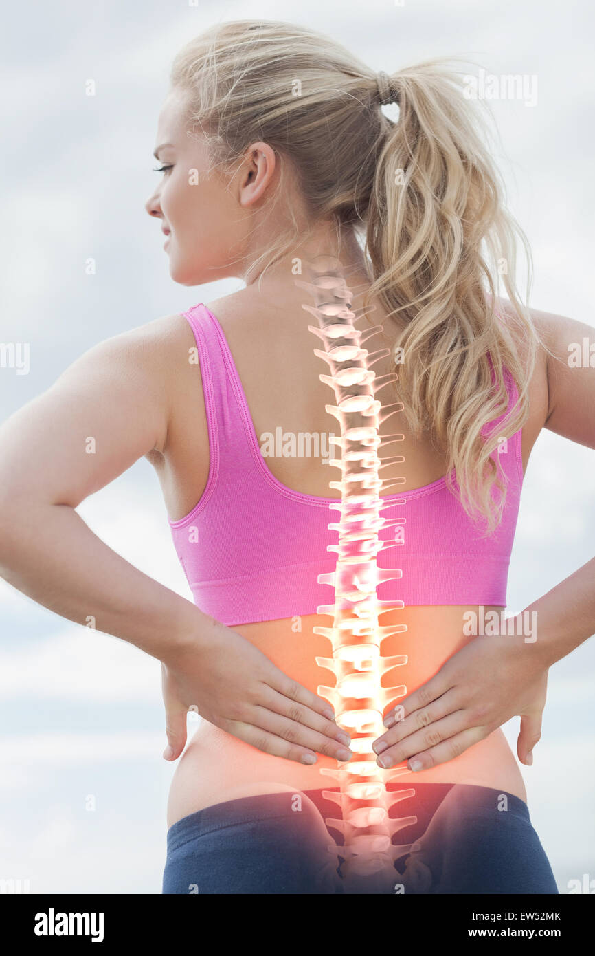 Highlighted spine of woman with back pain Stock Photo