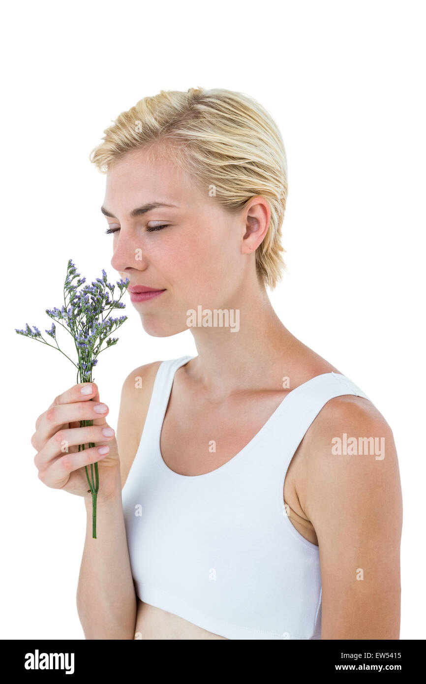 Gorgeous blonde woman smelling flowers Stock Photo