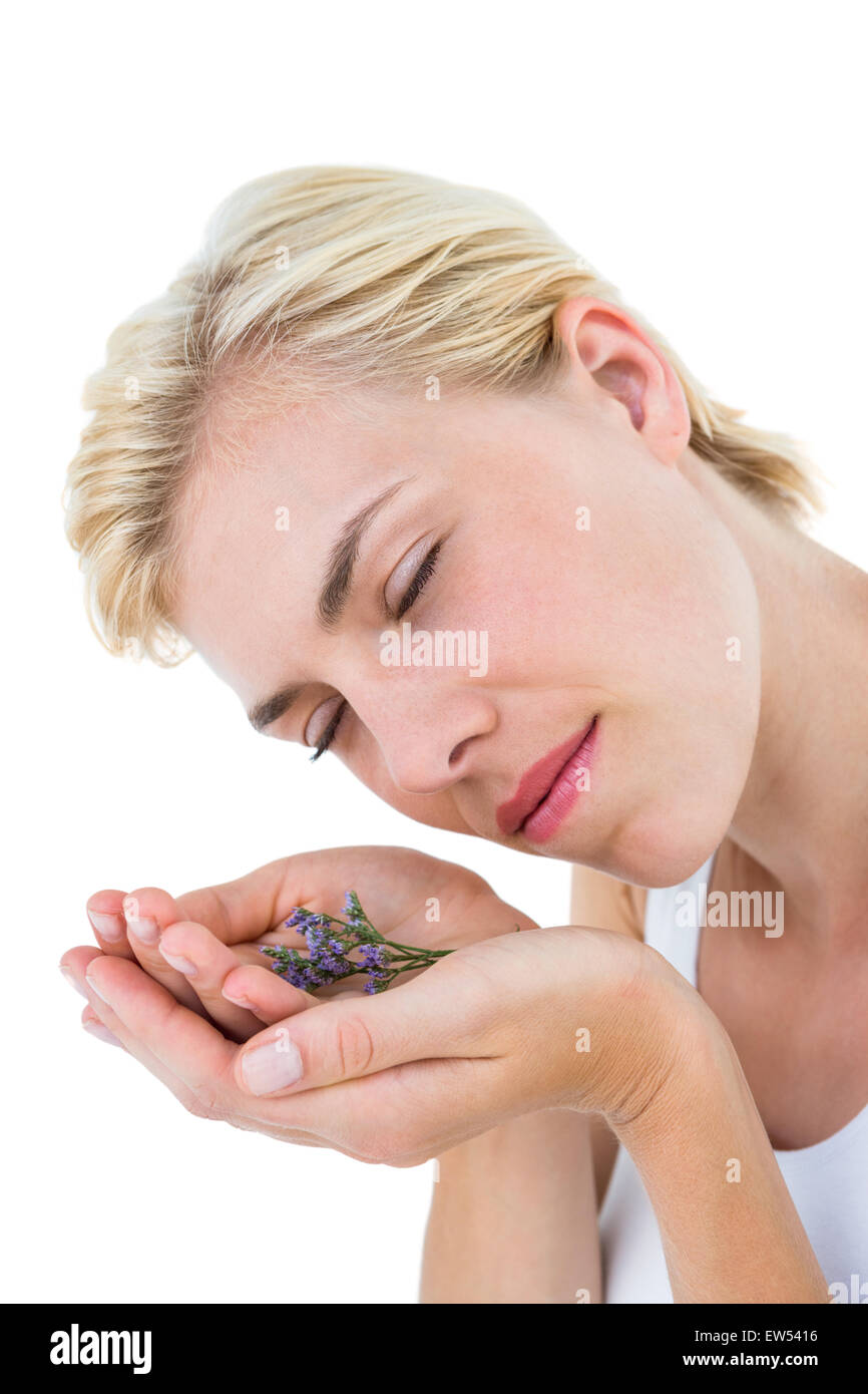 Gorgeous blonde woman smelling flowers Stock Photo