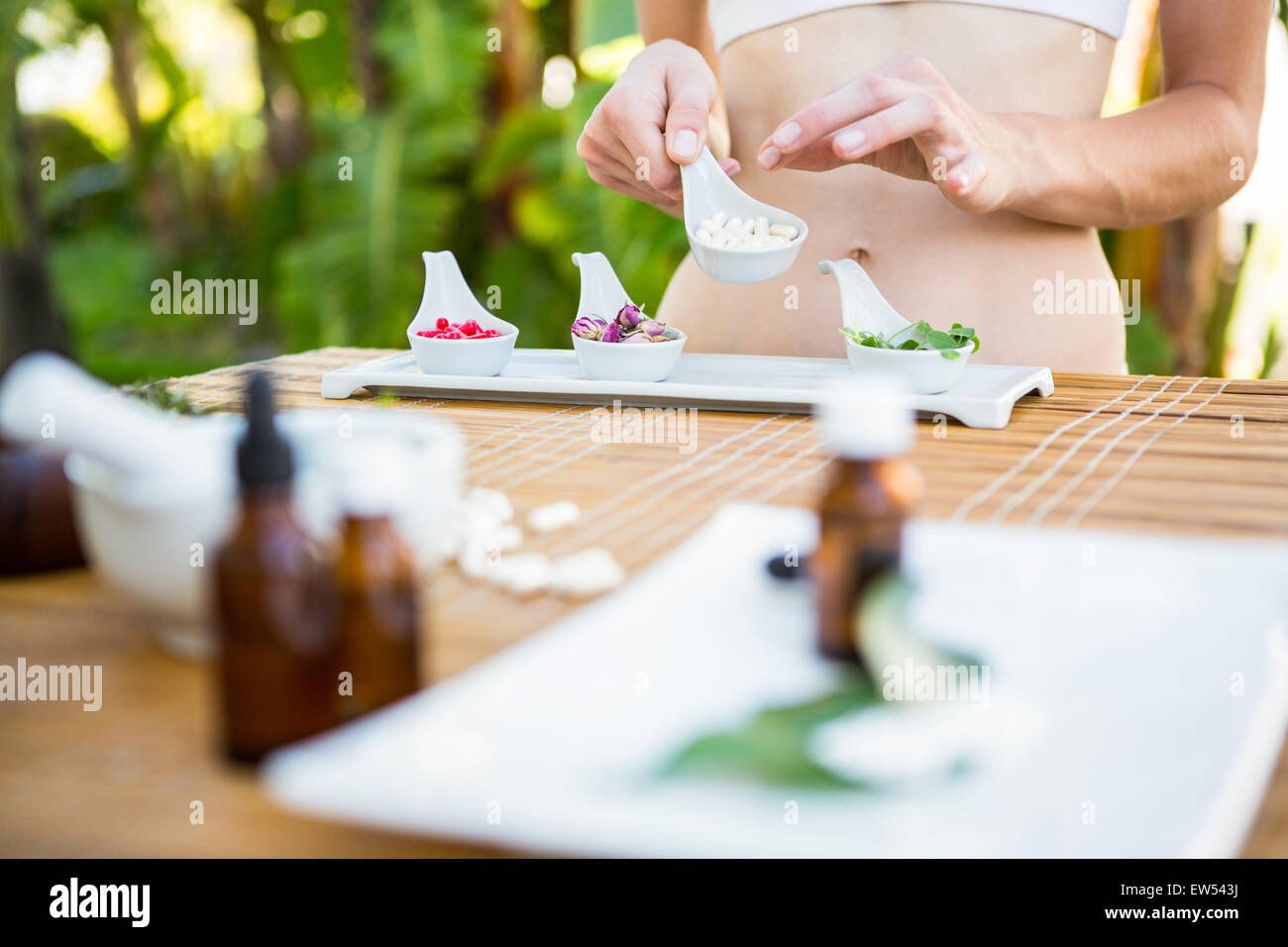 Fit woman holding plate with herbal medicine Stock Photo