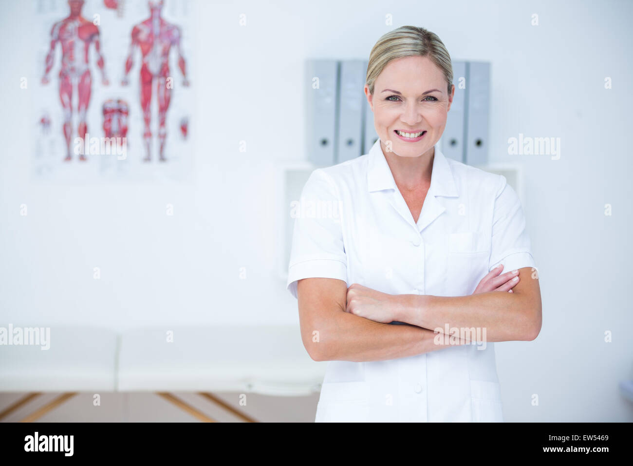 Happy doctor looking camera arms hi-res stock photography and images ...