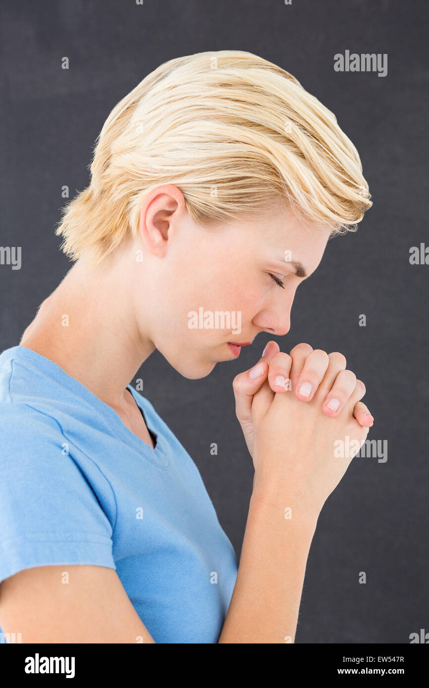 Pretty blond woman praying Stock Photo
