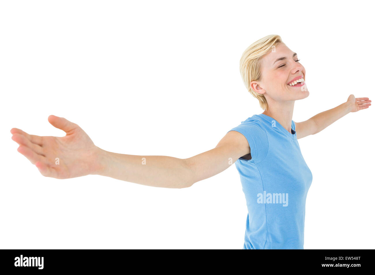 Blonde woman standing arms outstretched Stock Photo