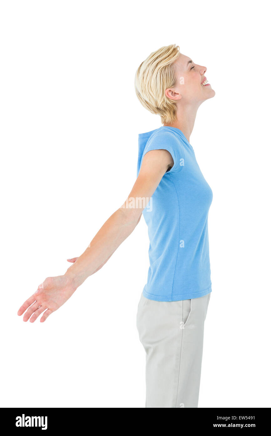 Blonde woman standing arms outstretched Stock Photo