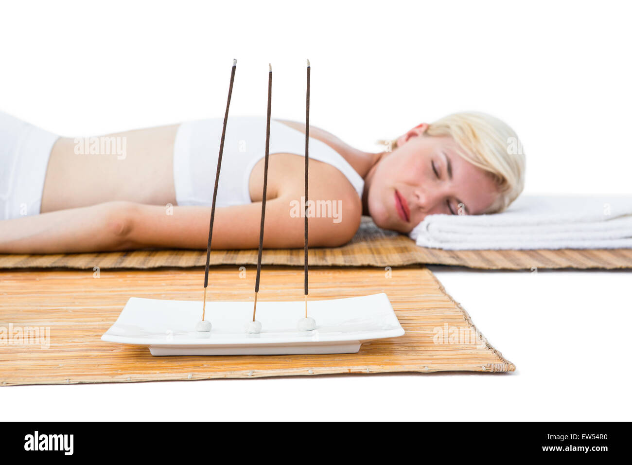 Attractive blonde woman resting on bamboo mat Stock Photo