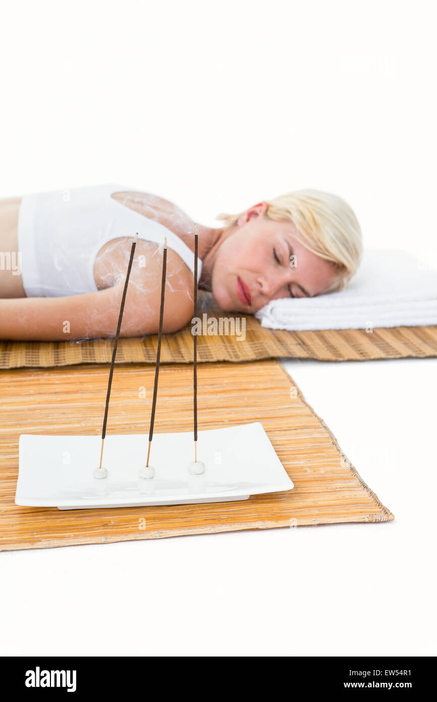 Attractive blonde woman resting on bamboo mat Stock Photo