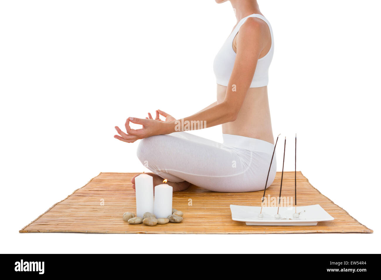 Fit woman meditating on bamboo mat Stock Photo