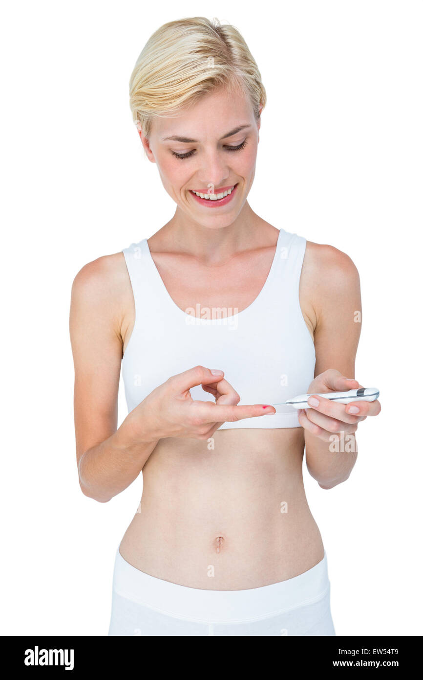 Attractive blonde woman doing test with blood glucose monitor Stock Photo