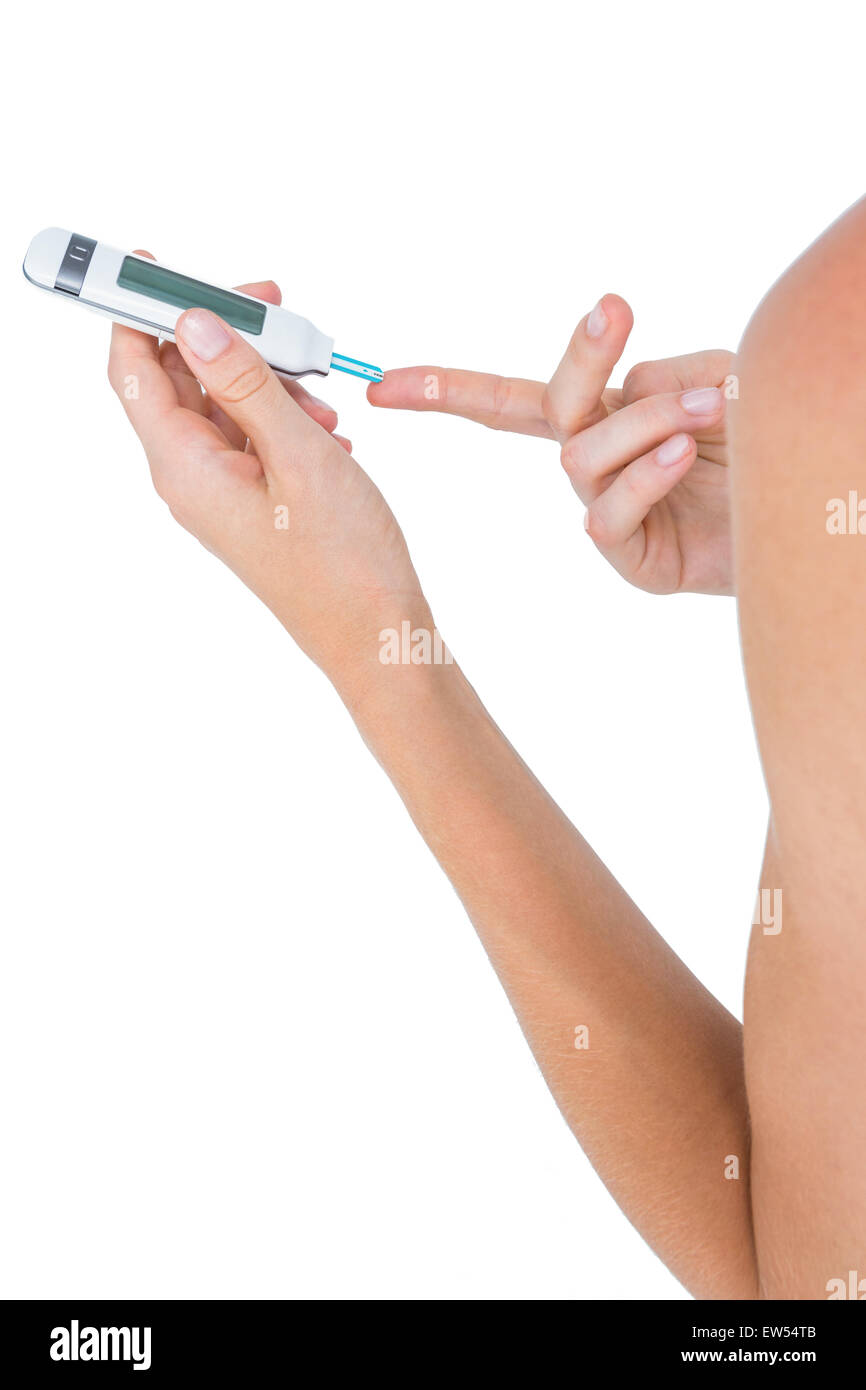 Woman doing test with blood glucose monitor Stock Photo