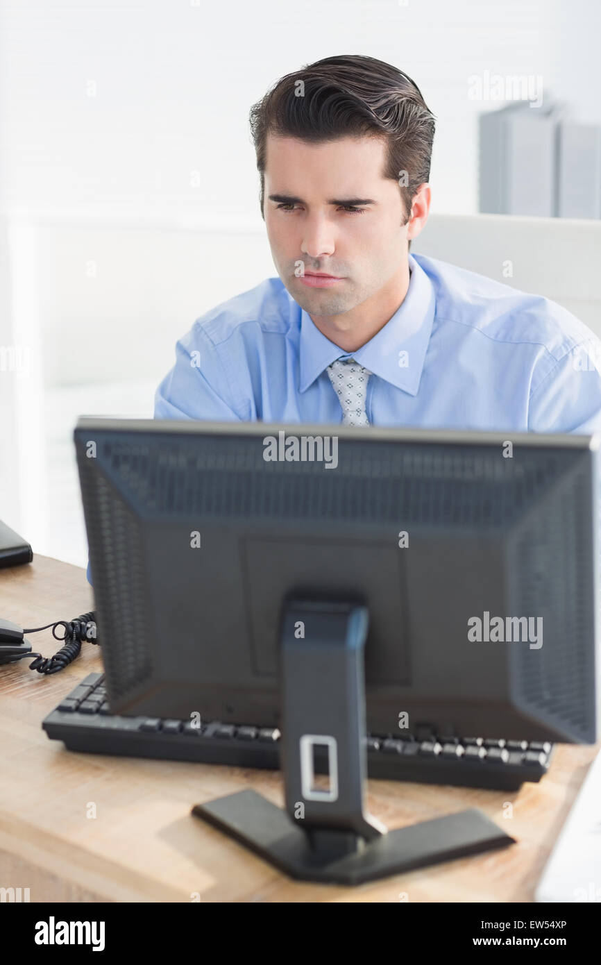 Concentrated businessman using his computer Stock Photo
