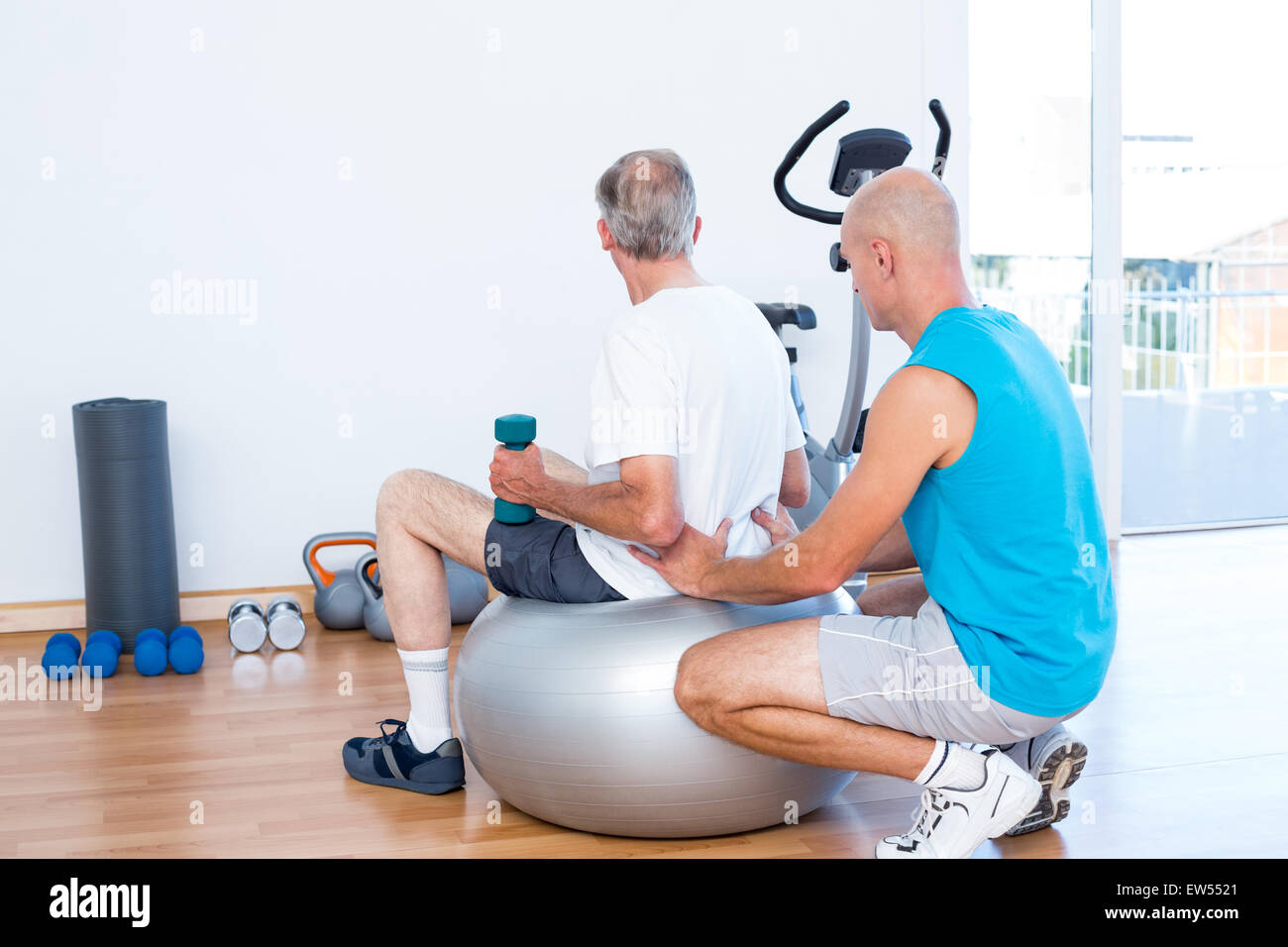 old man having back massage on exercise ball Stock Photo