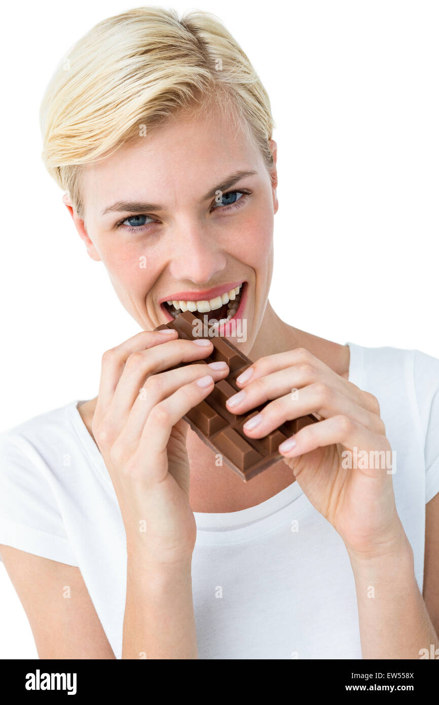 Attractive woman biting bar of chocolate Stock Photo