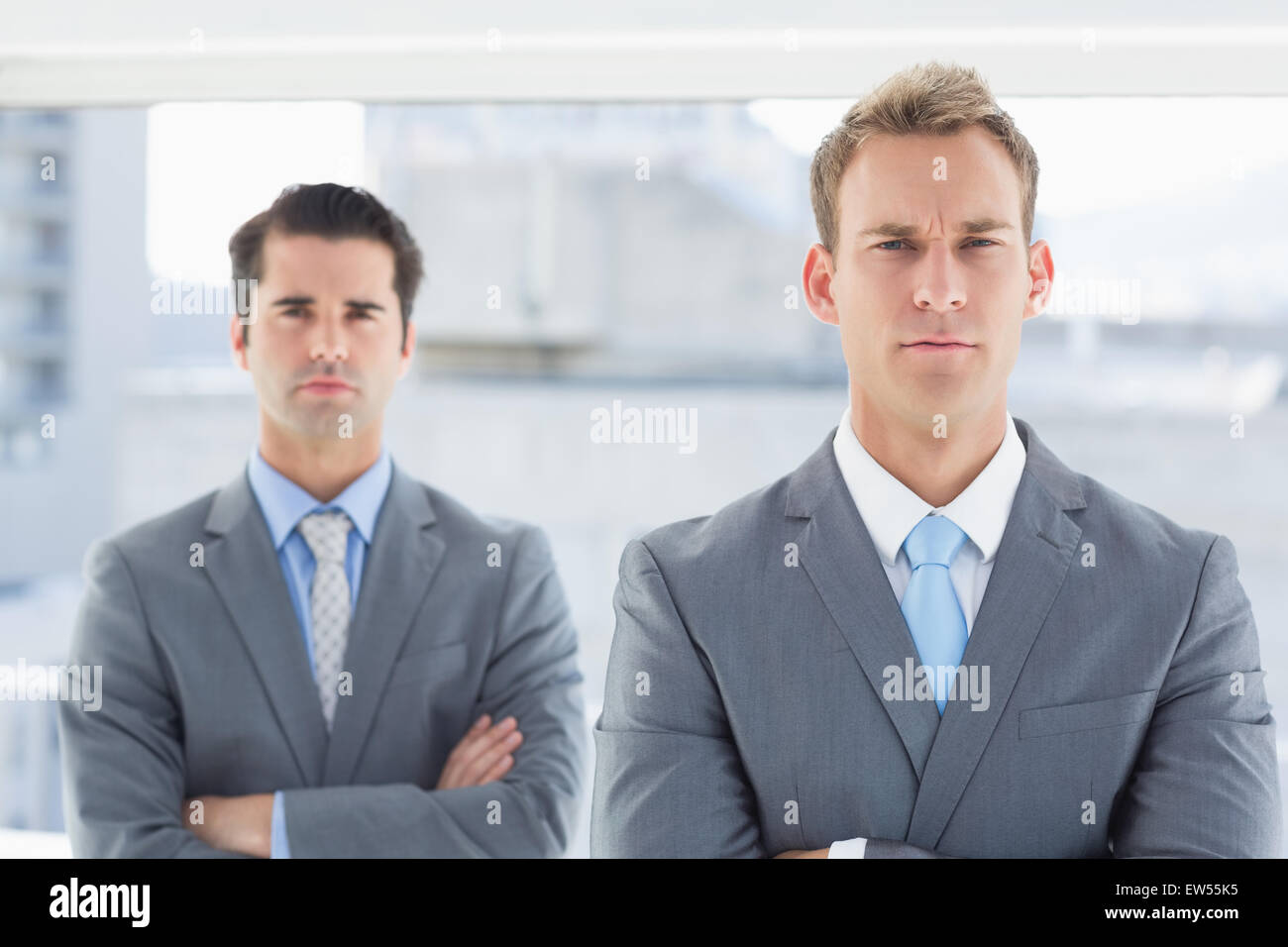 Two businessmen frowning at camera Stock Photo